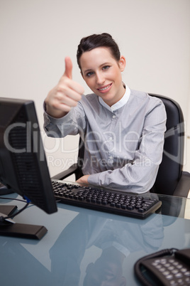Smiling businesswoman giving thumb up