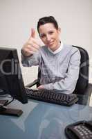 Smiling businesswoman giving thumb up