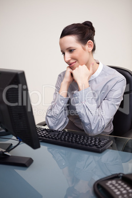 Happy smiling businesswoman sitting at her desk