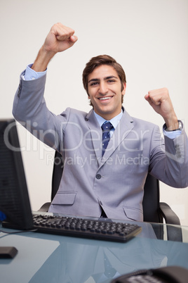 Businessman raising his fists in success