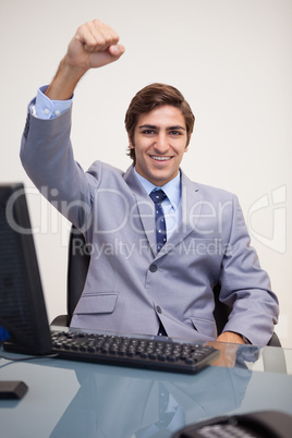 Businessman raising his fist in success