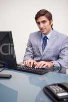 Businessman typing on his keyboard