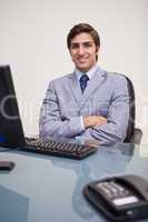 Businessman with folded arms leaning back satisfied