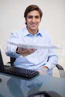 Smiling businessman handing over paperwork