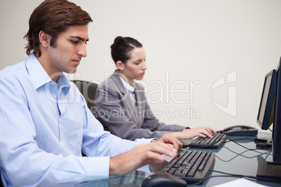 Side view of business team working next to each other