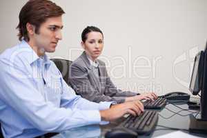 Side view of business team working on their computers