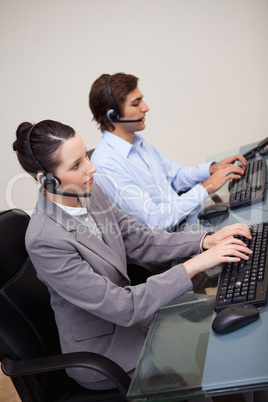 Side view of call center agents at work