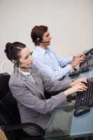 Side view of call center agents at work