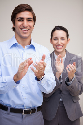 Standing business team clapping