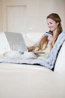 Woman on the sofa doing online shopping