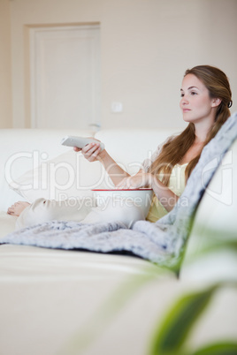 Woman on the sofa enjoying a movie with popcorn