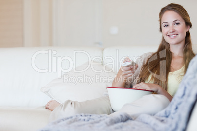 Woman with a bowl of popcorn watching a movie