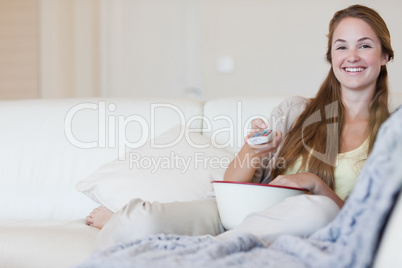 Woman having some popcorn while enjoying a movie