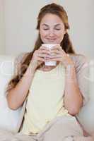 Woman enjoys smelling on her fresh made coffee