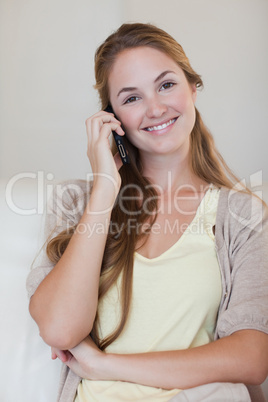 Smiling woman having a conversation on her cellphone