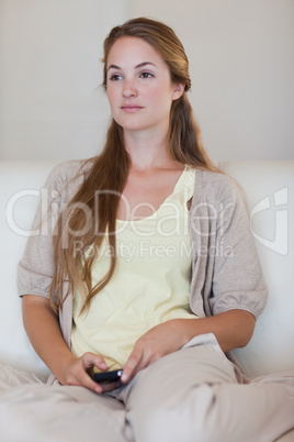 Woman with cellphone in thoughts