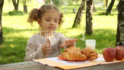 little girl breakfast in nature