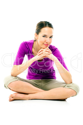 Young woman sitting on the floor on white background studio