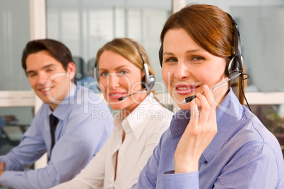 two businesswomen with microphone and a businessman during a mee