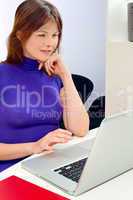 portrait of a young caucasian woman in office with laptop