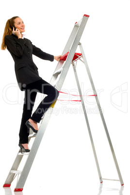 young businesswoman with cellphone on a scale on white backgroun