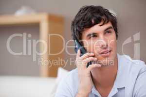 Man on the cellphone sitting in the living room