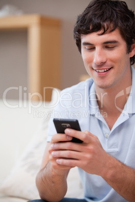 Smiling man writing textmessage