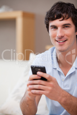 Smiling man with cellphone in his hands