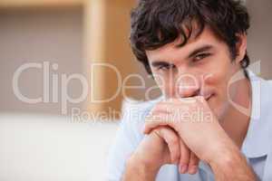 Man with hands folded in the living room