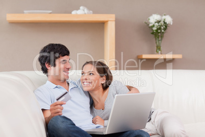 Cheerful couple booking holiday online