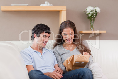 Couple on the couch with parcel