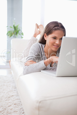 Woman on the sofa browsing the internet