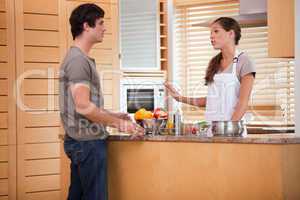 Couple talking in the kitchen