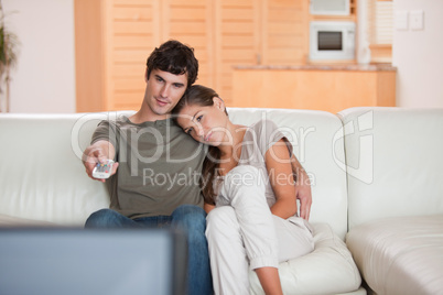 Couple on the sofa watching television together