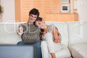 Couple on the couch watching television together