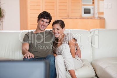 Couple on the sofa watching a movie together