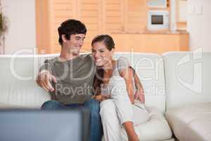 Couple on the sofa enjoying a movie together