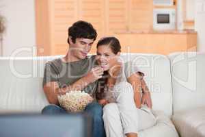 Couple on the couch watching a movie together