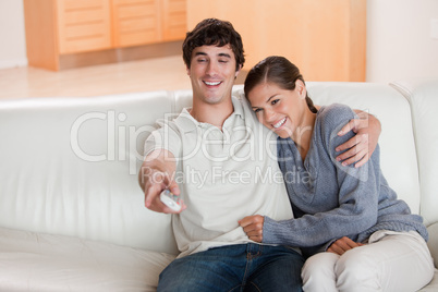 Couple watching television on the sofa