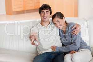 Couple watching television on the sofa