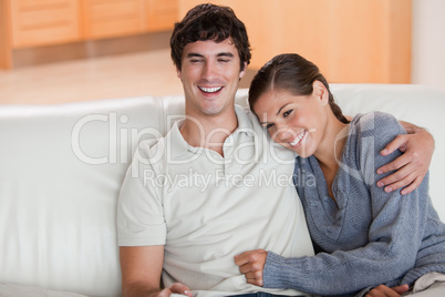 Happy couple enjoying their time together on the sofa