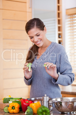 Smiling woman in the kitchen preparing vegetable stew