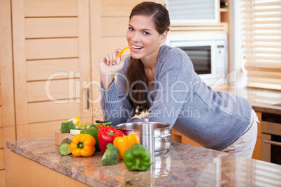 Smiling woman in the kitchen with vegetables