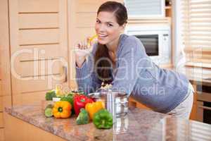 Smiling woman in the kitchen with vegetables