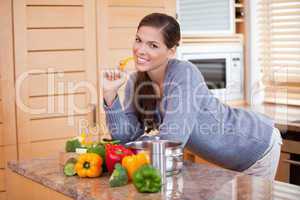 Smiling woman with healthy vegetables in the kitchen