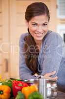 Smiling woman leaning against the kitchen counter