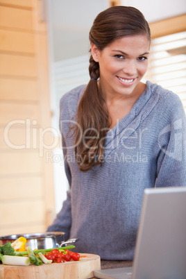 Woman in the kitchen looking for recipe online