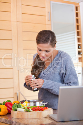 Woman spicing her meal
