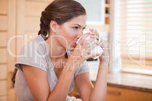 Side view of woman drinking coffee