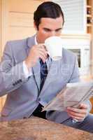 Businessman reading news and having a coffee